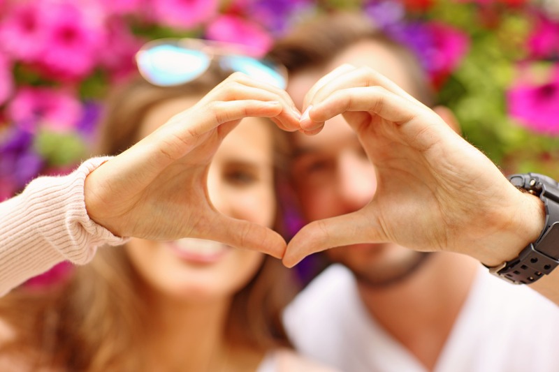 couple amoureux faisant un cœur avec les mains