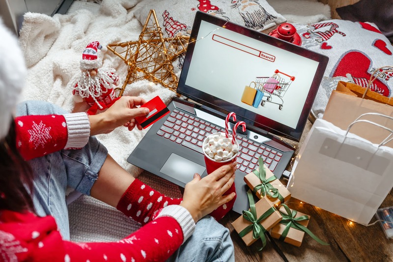 jeune femme faisant du shopping en ligne avec une carte cadeau de noël