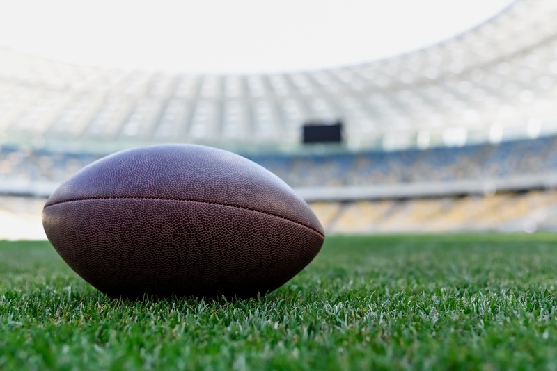 un ballon ovale sur une pelouse lors de la visite d'un stade mythique du rugby pour fan de rugby