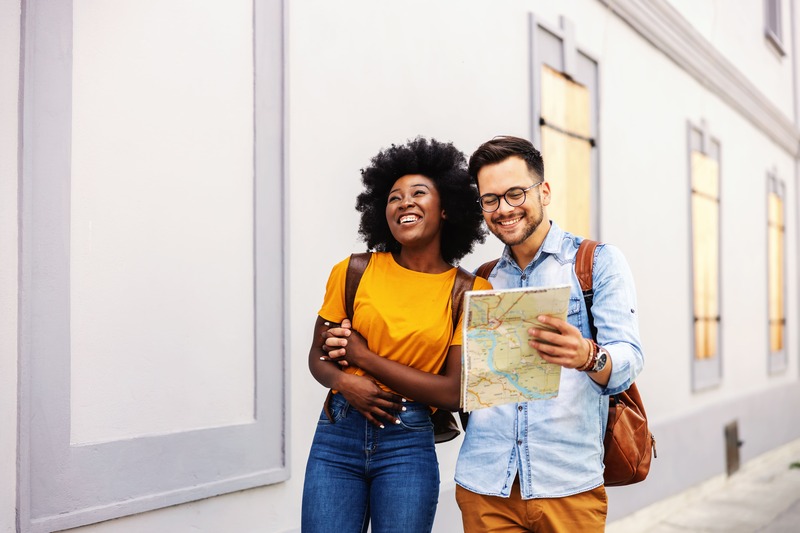 couple de jeune mariés heureux en voyage citadin se guide avec une carte de la ville pendant le week-end